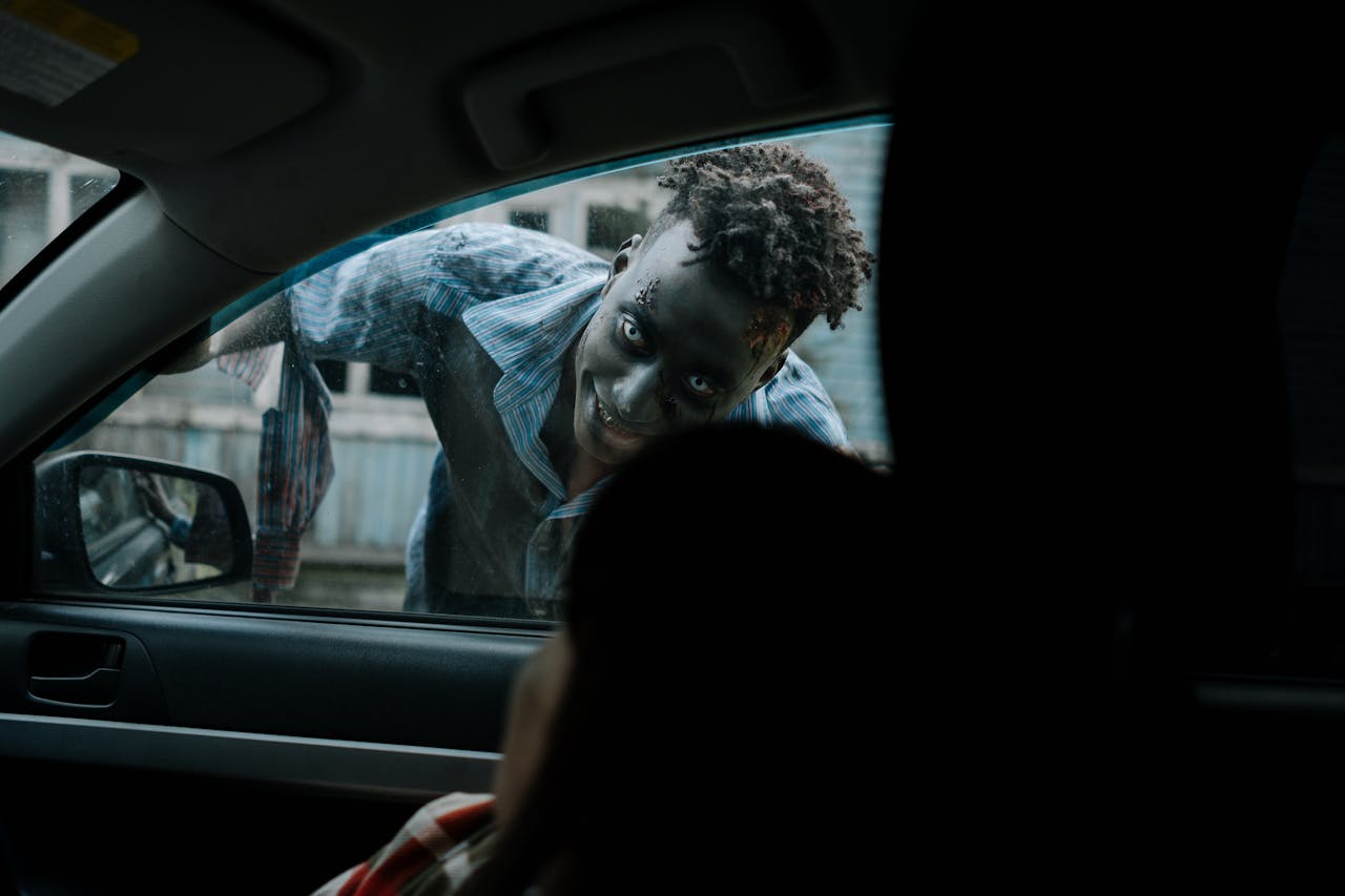 Frightening zombie peering through a car window during a horror scene.